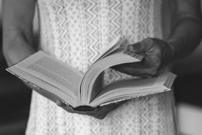 Midsection of woman reading book