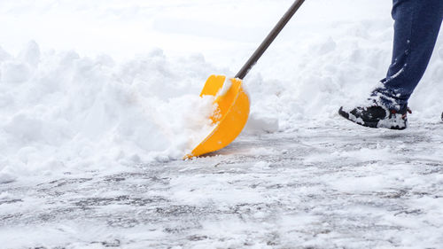 Low section of man skiing on snow