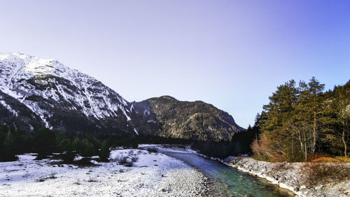 Scenic view of snowcapped mountains against clear sky