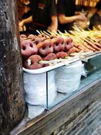 Midsection of man preparing food at market stall