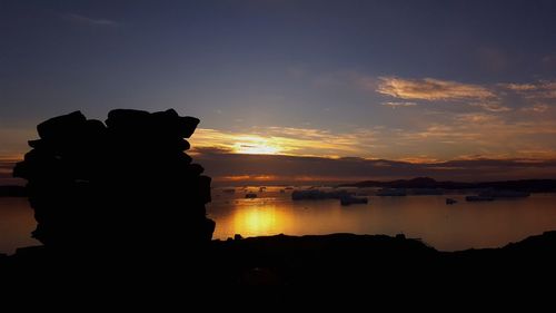 Silhouette statue against sky during sunset