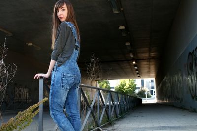 Full length of woman standing by railing
