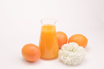 Close-up of orange fruit against white background