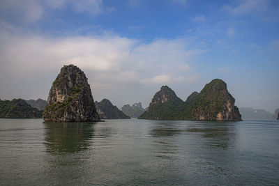 Rock formation in sea against sky