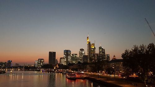 Illuminated buildings in city at waterfront