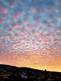 Scenic view of dramatic sky over town