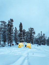 Information sign on snow covered field against sky