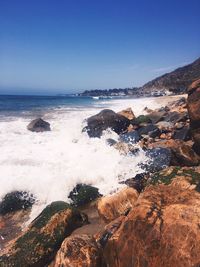 Scenic view of sea against clear blue sky