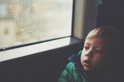 High angle view of boy looking through train window