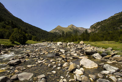 Rocks in mountains against clear sky