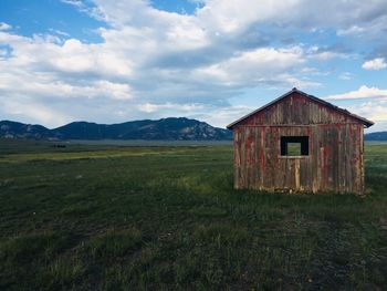 Built structure on field against sky