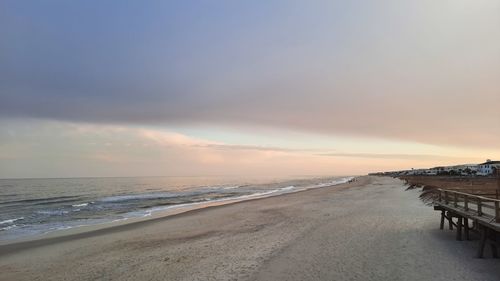 Scenic view of beach against sky during sunset