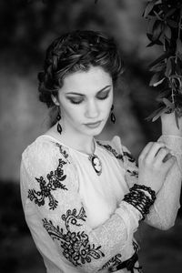 Portrait of young woman looking away outdoors
