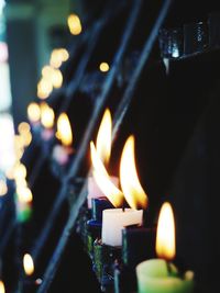 Close-up of burning candles in temple