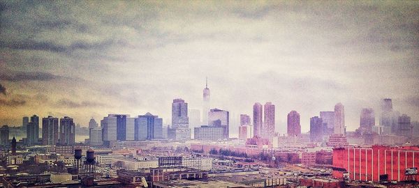 Cityscape against cloudy sky