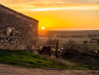 Scenic view of field against sky during sunset