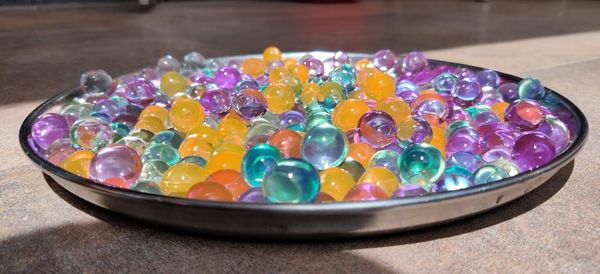 High angle view of multi colored candies in bowl on table