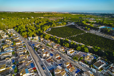 High angle view of cityscape by sea against sky