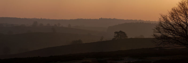 Scenic view of silhouette landscape against sky during sunset