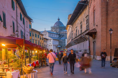 People walking on street in city