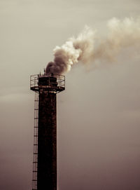 Smoke stacks against sky