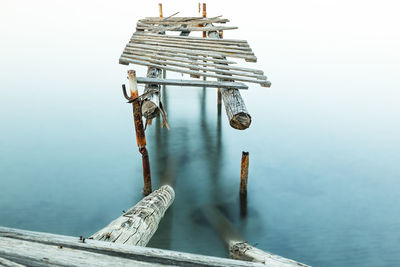 Abandoned wooden pier over lake