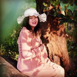 Portrait of smiling young woman wearing hat
