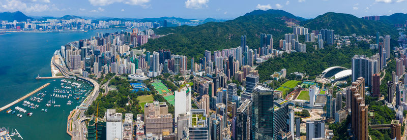 Aerial view of sea and buildings against sky