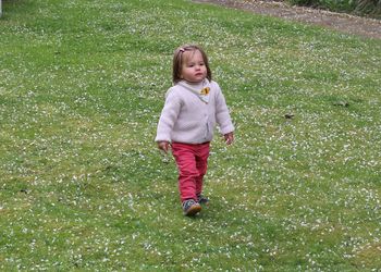 Full length of girl standing on field