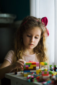 Girl playing with multicolored blocks