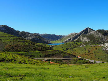 Scenic view of mountains against clear blue sky