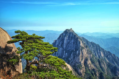 Scenic view of mountains against blue sky