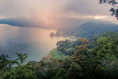 Scenic view of tree mountains against sky during sunset