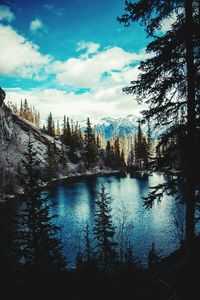 Scenic view of lake against cloudy sky