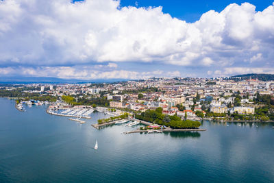 High angle view of townscape by river against sky