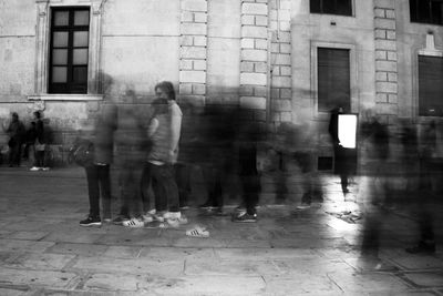 Blurred motion of man walking in city