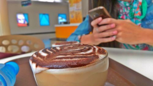 Close-up of fresh coffee on table at cafe