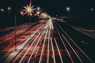 High angle view of light trails on railroad tracks at night