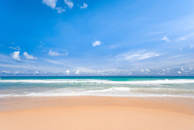 Scenic view of beach against blue sky
