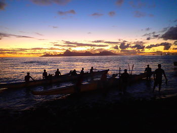 People on beach at sunset