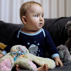 Close-up of cute boy with stuffed toy at home