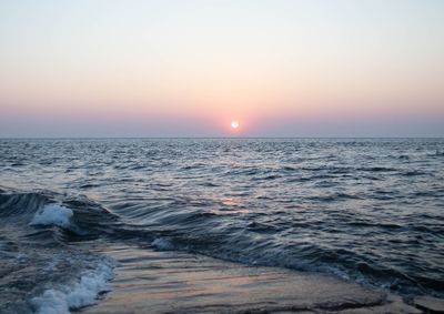 Scenic view of sea against clear sky during sunset