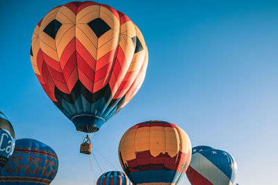 Low angle view of hot air balloon against blue sky