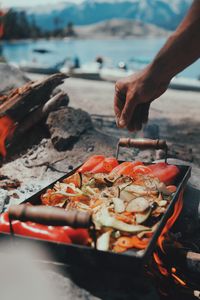 Midsection of person preparing food at beach