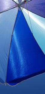 Low angle view of parasol against sky