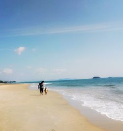 Man on beach against sky