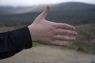 Close-up of man hand on rock