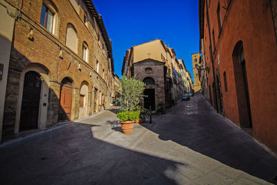 Street amidst buildings against sky