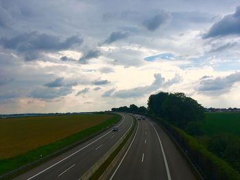 Road passing through landscape against sky