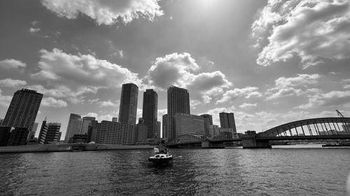 Modern buildings in city against cloudy sky